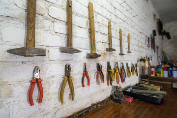 Old wooden hammers hanging on a wall in workshop