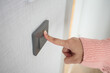 © Towfiqu Barbhuiya  - A finger turning on lighting switch .