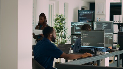 Database programer working on html script code to develop program app server with new use rinterface. Web developer typing on keyboard, computing big data on terminal window in office.