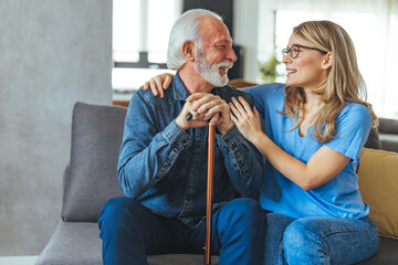 Wall Mural - Cropped shot of an attractive young nurse sitting and comforting a senior patient in the living room of his home. Doctor or nurse caregiver with senior man at home or nursing home