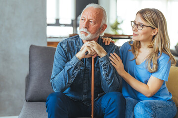 Wall Mural - Cropped shot of an attractive young nurse sitting and comforting a senior patient in the living room of his home. Doctor or nurse caregiver with senior man at home or nursing home