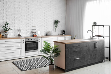 Sticker - Interior of light kitchen with white counters, electric oven and houseplants