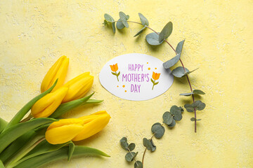 Canvas Print - Card with text HAPPY MOTHER'S DAY, beautiful tulip flowers and eucalyptus branches on yellow background