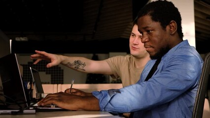 Two programmers working in the office of a software development company. Coding technologies, site design. Successful diverse Teamwork. Cyberspace concept.