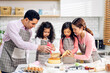 © Art_Photo - Portrait of enjoy happy love asian family father and mother with little asian girl daughter child play and having fun cooking food together with baking cookie and cake ingredient in kitchen