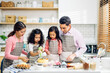 © Art_Photo - Portrait of enjoy happy love asian family father and mother with little asian girl daughter child play and having fun cooking food together with baking cookie and cake ingredient in kitchen