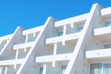Tropical Resort Building Exterior View . White Building Against Blue Sky 