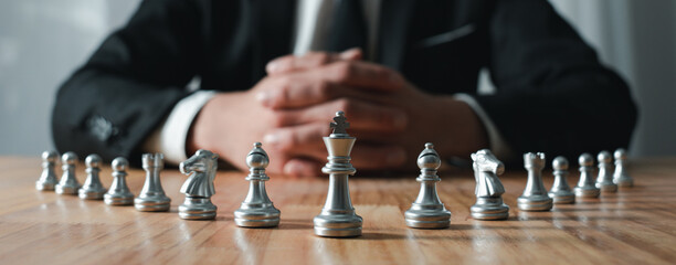 young businessman asian man sitting holding hands looking at the chess set, strategy concept, and bu