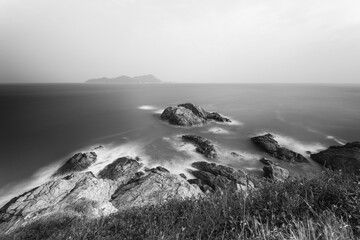 Wall Mural - waves crashing on rocks, long exposure, black and white