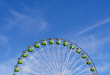 Green Ferris Wheel Against Clear Blue Sky