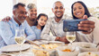 © J Bettencourt/peopleimages.com - Black family selfie, lunch and smile in home with men, women and girl at table for celebration on web app. Man, smartphone photography and profile picture for social media with kid, parents and woman