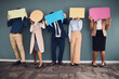 © Sharne T/peopleimages.com - Business people, speech bubbles and communication in workplace, logo and feedback against grey wall. Group, staff and teamwork for advertise campaign, opinion and announcement with banner or creative