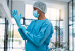 © Anela R/peopleimages.com - Surgeon, doctor with gloves and surgery with face mask and health, man in ppe for safety, operation and ready for procedure. Cardiovascular, clean scrubs and person in clinic with male physician