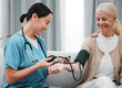Nurse, doctor or old woman with blood pressure test consulting in hospital to monitor heart wellness. Healthcare, hypertension consultation or medical physician with a happy patient for examination