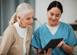 © Mumtaaz D/peopleimages.com - Tablet, news or nurse with old woman consulting after surgery or medical test results for support. Meeting, healthcare clinic or doctor reading or helping a sick elderly patient with an online report