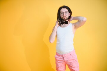 Young, handsome gay man on a colored background in the studio. LGBT concept.