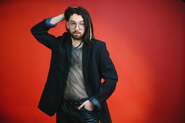 Young, handsome gay man on a colored background in the studio. LGBT concept.