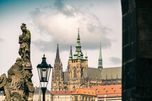 View From Charles Bridge With Statues With The Prague Castle And St. Vitus Cathedral In The Background