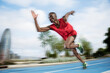 © Cavan Images - Male athlete sprinting on all-weather running track, Barcelona, Spain