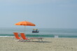 Umbrellas on the sand. Umbrellas on the beach. The sea of Viareggio in Versilia. In the background a yacht. 