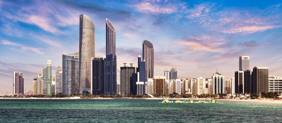 Wall Mural - Abu Dhabi skyline with reflection in sea, United Arab Emirates - panorama
