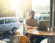 © M Moller/peopleimages.com - Todays tech allows you to work anywhere. Shot of a young man working on his laptop in a coffee shop.