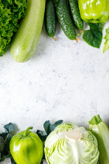 Wall Mural - Border of green raw vegetables on white background. Top view of healthy organic food. Copy space