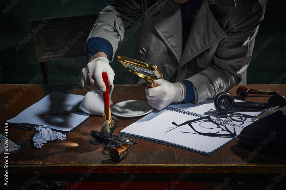 Detective Measures Cropped image of detective's hand finding fingerprints on gun, clues on ...