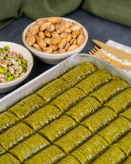 Pistachio baklava on white marble. Traditional middle eastern dessert. Turkish Antep baklava.