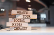 Wooden blocks with words 'What's Your Social Media Impact?'.