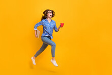 Full Size Profile Photo Of Amazed Girl Hold Laptop Coffee Mug Jump Run Empty Space Isolated On Yellow Color Background