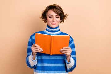 Poster - Photo of dreamy pretty woman dressed striped sweater reading interesting book isolated beige color background