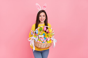 Poster - Photo of young pretty woman hold eggs stick pastry event costume isolated over pink color background