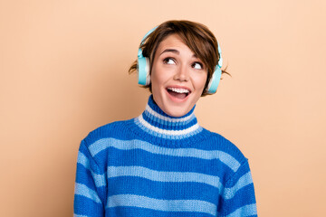 Sticker - Photo of funny funky lady wear blue pullover headphones looking empty space isolated beige color background