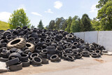 Fototapeta  - Heap of old used industrial rubber tires specially selected from the garbage in a recycling plant for separate recycling