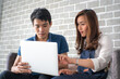 © themorningglory - Business man and woman working in office wioth laptop brainstorm business plan