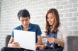 © themorningglory - Business man and woman working in office wioth laptop brainstorm business plan