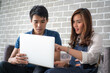 © themorningglory - Business man and woman working in office wioth laptop brainstorm business plan