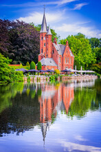 Bruges, Belgium. Minnewater, Tranquil Lake With Lush Greenery In Romantic