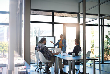 Poster - Going over all the facts and figures. Shot of a young businesswoman giving a presentation in the boardroom.