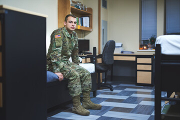 Wall Mural - Some call it a dorm, I call it home. Shot of a young soldier sitting on his bed in the dorms of a military academy.