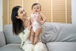 © tonefotografia - Portrait of mother and baby girl at home, family, child, childhood and parenthood concept