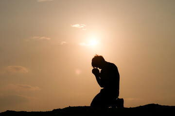 Wall Mural - Silhouette of man praying for god's blessing. hope concept