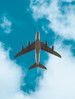 © Adam Rhodes - Aeroplane in flight beneath a blue sky with clouds, low flying plane, airbus aircraft