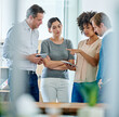 © Yuri A/peopleimages.com - Everybodys input is important. Shot of a group of office colleagues having a discussion over a digital tablet.