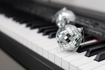 Wall Mural - Christmas ball on piano keys. Carol music concept