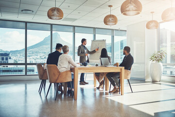 Poster - Creating a powerful action plan together. Shot of a businessman giving a presentation to his colleagues in an office.