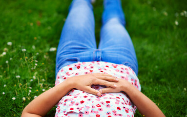 Sticker - Completely relaxed.... Cropped shot of a woman relaxing on a patch of grass.