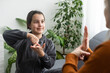 © Angelov - daughter talk with middle aged mother people using sign language, family sitting on armchair side view, teacher teach teenager deaf-mute girl to visual-manual gestures symbols concept image