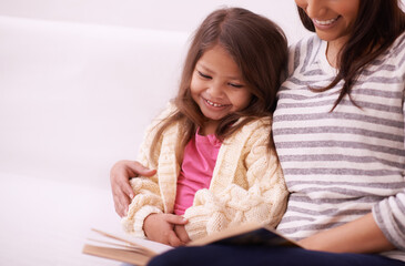 Sticker - She loves fairytales. Cropped shot of a young mother reading to her daughter at home.